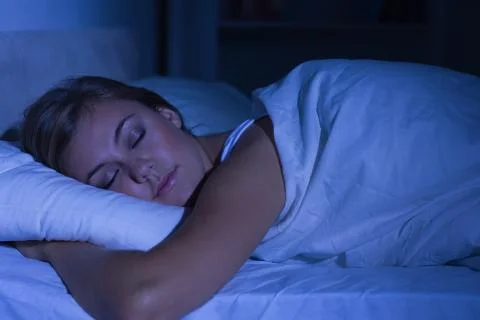 Serene woman sleeping at night Stock Photos