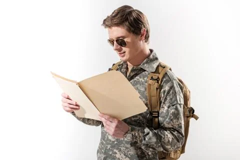 Serene young soldier exploring data in folder Stock Photos