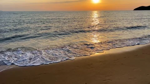 A serenely wavy beach at sunset Stock Footage 275900639