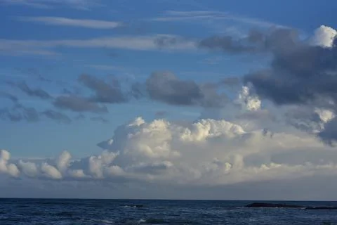 Serenity at Dusk When Clouds Touch the Sea Stock Photos