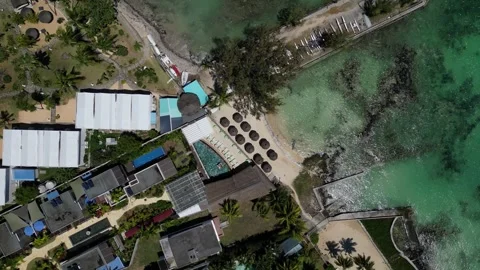 Serenity Skyfall: Aerial View of Beachside Paradise 4K Drone Descend Stock Footage 259098739