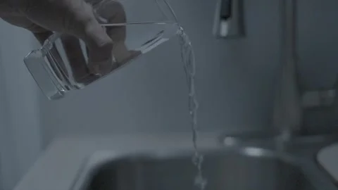 Serenity Unleashed: Slow Motion Water Pour from Glass to Sink Stock Footage 257293094
