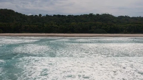 Serfs on the water, view from above, waves, beach and beautiful palm trees Stock Footage 106571075