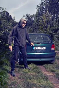 Serial killer attacking and hijacking man in park Stock Photos