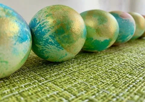 A series of decorative Easter eggs display vibrant colors and unique patterns. Stock Photos