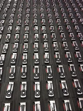 A series of GPU cards arranged vertically, stacked atop each other on a table 스톡 사진