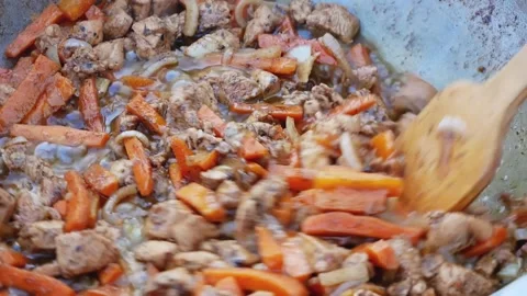 A series of the process of cooking pilaf in a cauldron on the street. handmade 動画素材 136779787