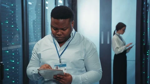Serious afro-american smart engineer using digital tablet in computer render Stock Footage 119734649