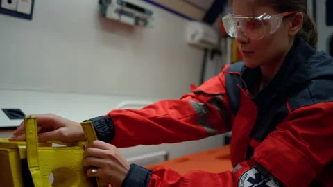 Serious ambulance paramedic getting ready neck immobilizer in emergency vehicle Stock Footage 166909326