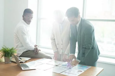 Serious analysts comparing graphs Stock Photos