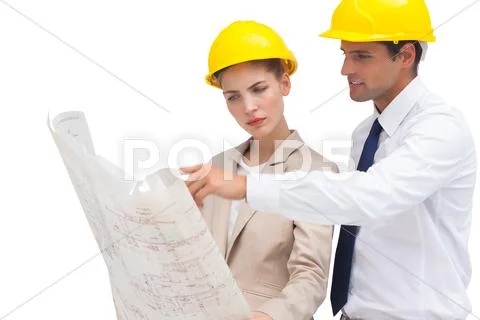 Serious architects looking at construction plan Stock Photos