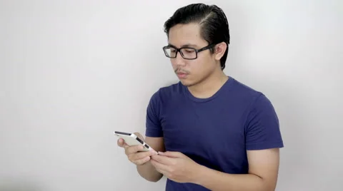 Serious Asian Man Texting With Smartphone On Studio White Background 4K Resol Stock Footage 59949697