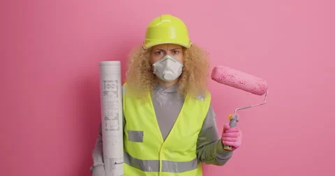 Serious attentive responsible female builder wears hardhat uniform and Stock Footage 155255687