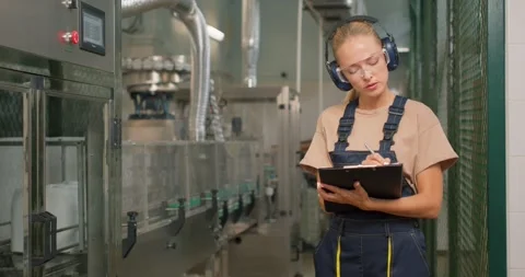 Serious attractive engineer concentrated on checking the industrial machine Stock Footage 268811170