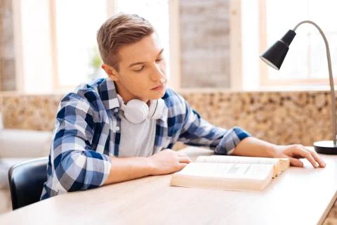Serious avid reader reading a book Stock Photos
