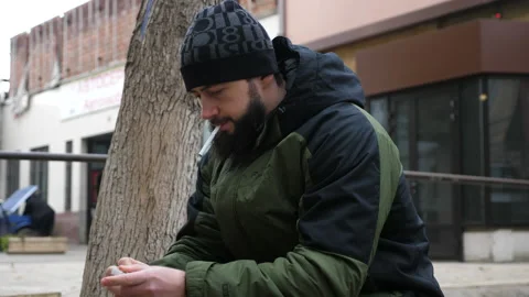 Serious bearded guy puts cigarette into mouth and lights Stock Footage 145715444