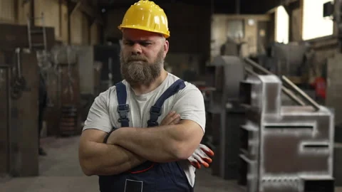 Serious bearded industrial worker posing with arms crossed Stock Footage 334723101