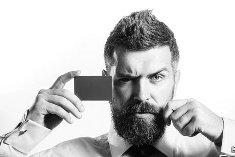 Serious bearded man with empty visiting card. Businessman, financier or ban.. Stock Photos