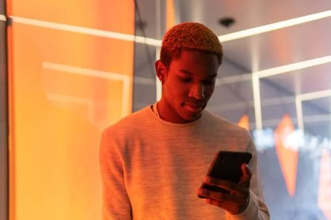 Serious black man using smartphone Stock Photos