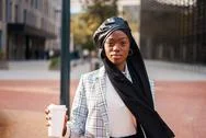 Serious Black Woman With Takeaway Coffee In Modern District Stock Photos
