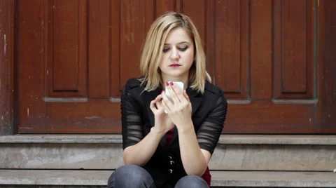 Serious blonde woman using smart phone Stock Footage 35006461