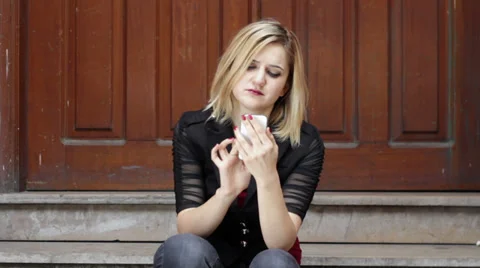 Serious blonde woman using smart phone Stock Footage 35006836