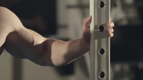 Serious bodybuilder stands in front of a mirror in the gym Stock Footage 48991953