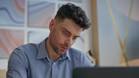 Serious boss looking computer screen at workplace closeup. Man solving tasks Foto stock