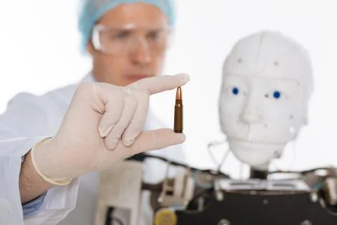 Serious brilliant scientist developing artificial intelligence for combat Stock Photos
