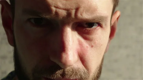 Serious brutal man looking at the camera close up portrait Stock Footage 122560698