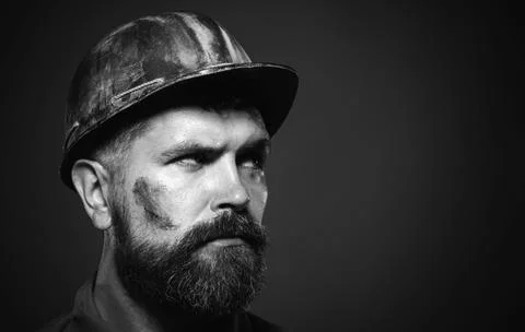 Serious builder in hard hat looking aside at copy space. Mechanical or indust Stock Photos