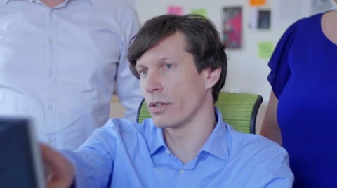 Serious Business man explaining project on screen to coworkers 스톡 동영상 49718900