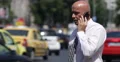 Serious Business Manager Smartphone Talking Financial Offer Terms Crowded Street 4k or 4k+ Resolution