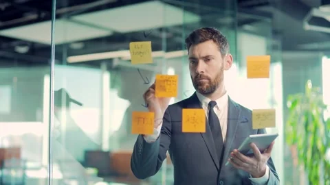 Serious businessman analyst develops a strategy for enterprise, financial  Video stock 167863043