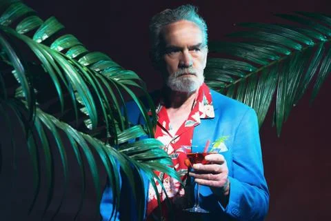 Serious Businessman with Drink in a Tropical Party Stock Photos