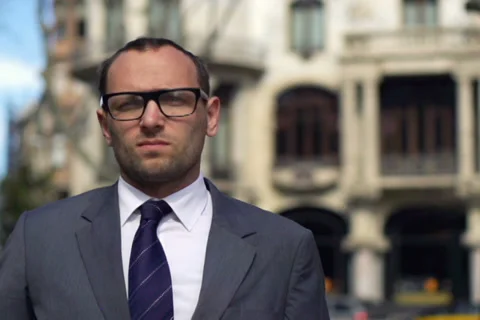 Serious businessman looking at camera in front of fountain, slow motion Stock-Footage 38649540