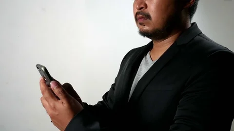 Serious Businessman man using smartphone Browsing and Text Messaging. Stock Footage 78200864