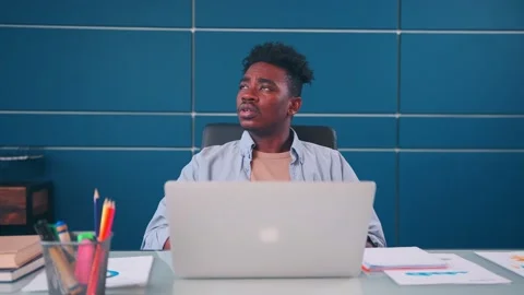 Serious businessman solving business problems working on laptop making notes Stock Footage 163915434