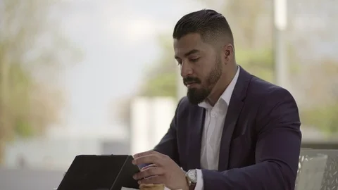 Serious businessman using digital tablet Video stock 106935101