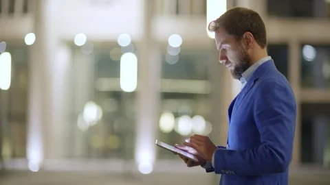 Serious businessman using tablet computer on the move 스톡 동영상 100690039