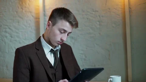 Serious Businessman working on tablet computer in the cafe Stock Footage 56892971