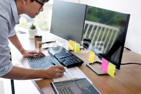 Serious busy hipster young web software developer programmer is coding or pro Stock Photos