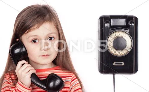 Serious child talking on phone isolated, white background Stock Photos