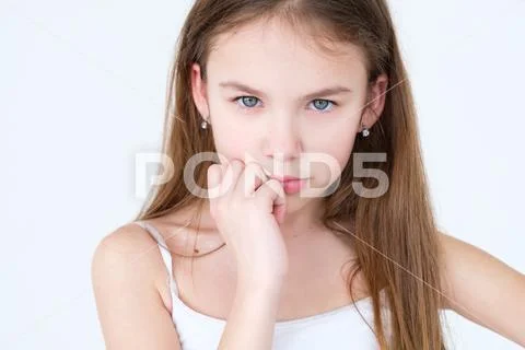 Serious child thinking hand under chin little girl Stock Photos