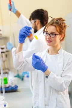 Serious clinicians studying chemical elements in laboratory Stock Photos