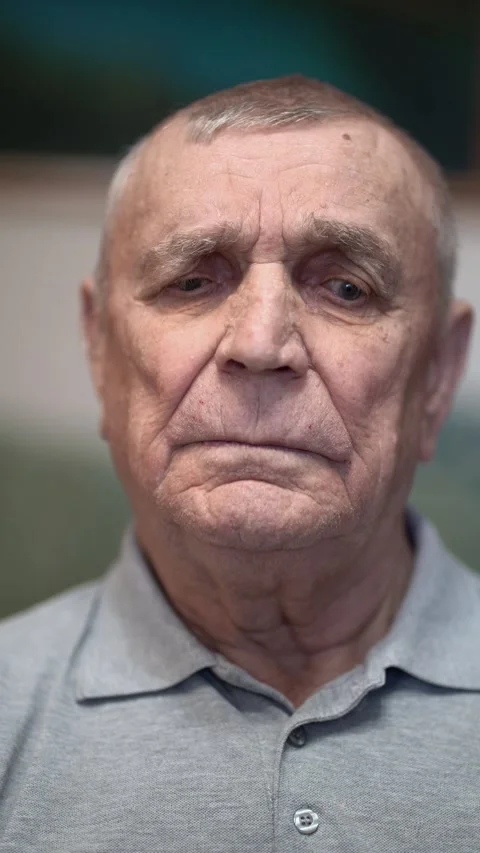 Serious close-up of an 80-year-old man with deep wrinkles, gray hair  Stock Footage 346175953