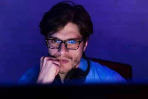 Serious concentrated developer working on computer at night Stock Photos