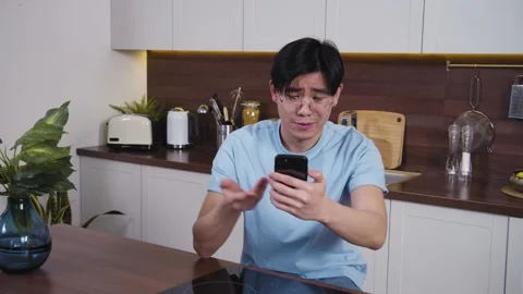 Serious confident man sitting at home kitchen. Talk to coach, business partner Stock Footage 153476894