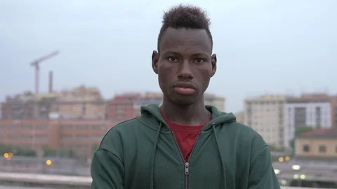 Serious confident young black african migrant staring at acmera-outdoor Stock Footage 107034553