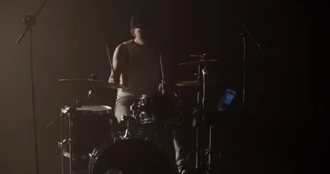 Serious cool guy performing song on drums during rehearsal Stock Footage 249852666